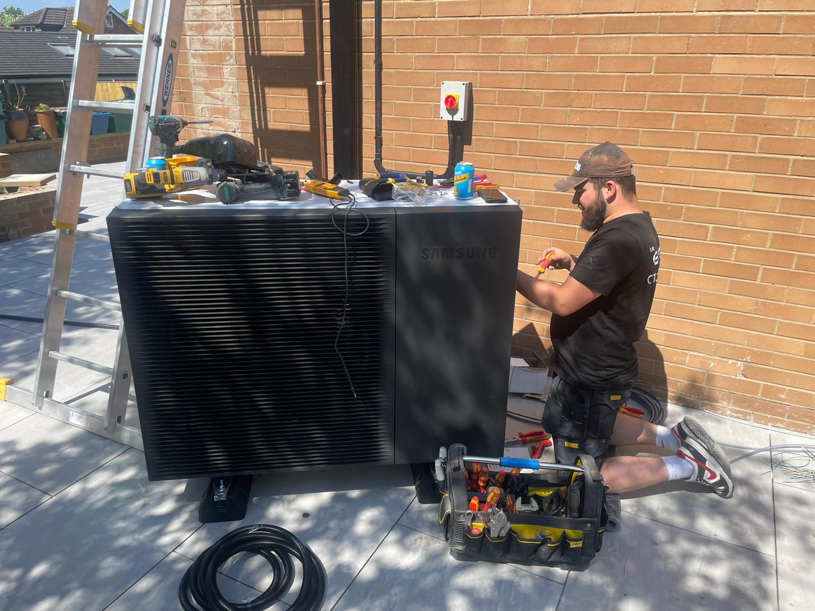 Engineer working on an air source heat pump