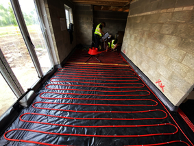 Underfloor heating pipes being laid in a new build home