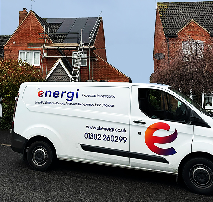 solar panels on roof with sun rising in background